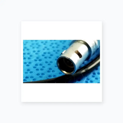 Silver-colored xlr audio connector with black cable attached to ace 765-1002 sterilization tray for multigen radiofrequency probe