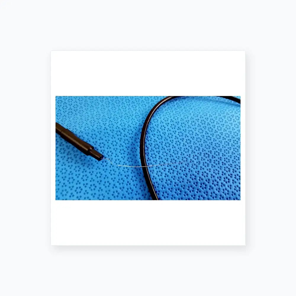 Black cable with thin metallic wire extending from sterlization tray with stryker 8400-815-005 multigen radiofrequency probe
