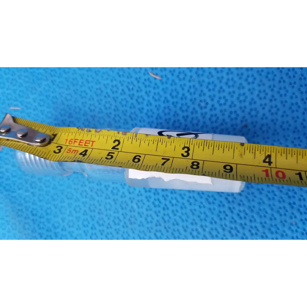 White plastic ace glass ace-thred thermometer adapter with threaded ends and a yellow measuring tape across it