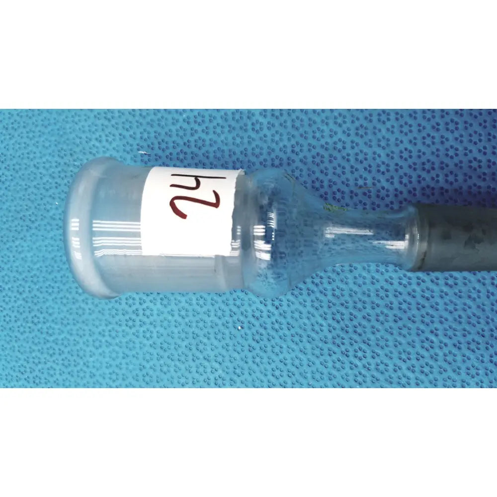 Clear plastic ace glass enlarging adapter vial with white 24 label and dark gray cap made of borosilicate glass