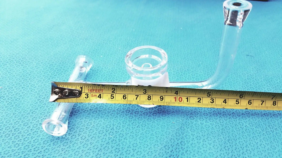 Ace glass straight bore stopcock made of clear borosilicate glass with a curved arm and metallic accents