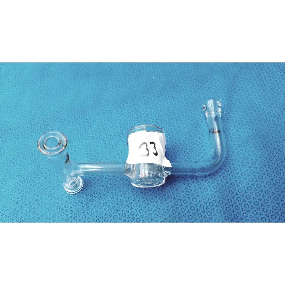Clear glass ace glass straight bore stopcock with sidearms and central cylindrical section labeled 33 for lab use