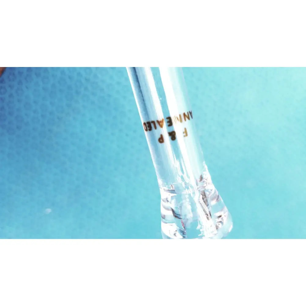 Clear glass test tube with gold engraved text f&p annealed containing clear liquid paired with ace glass straight bore stopcock adapter