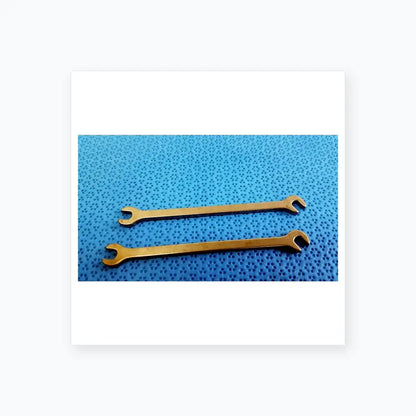 Two polished silver metallic open-end wrenches from ace ophthalmology micro surgery medical equipment on blue surface