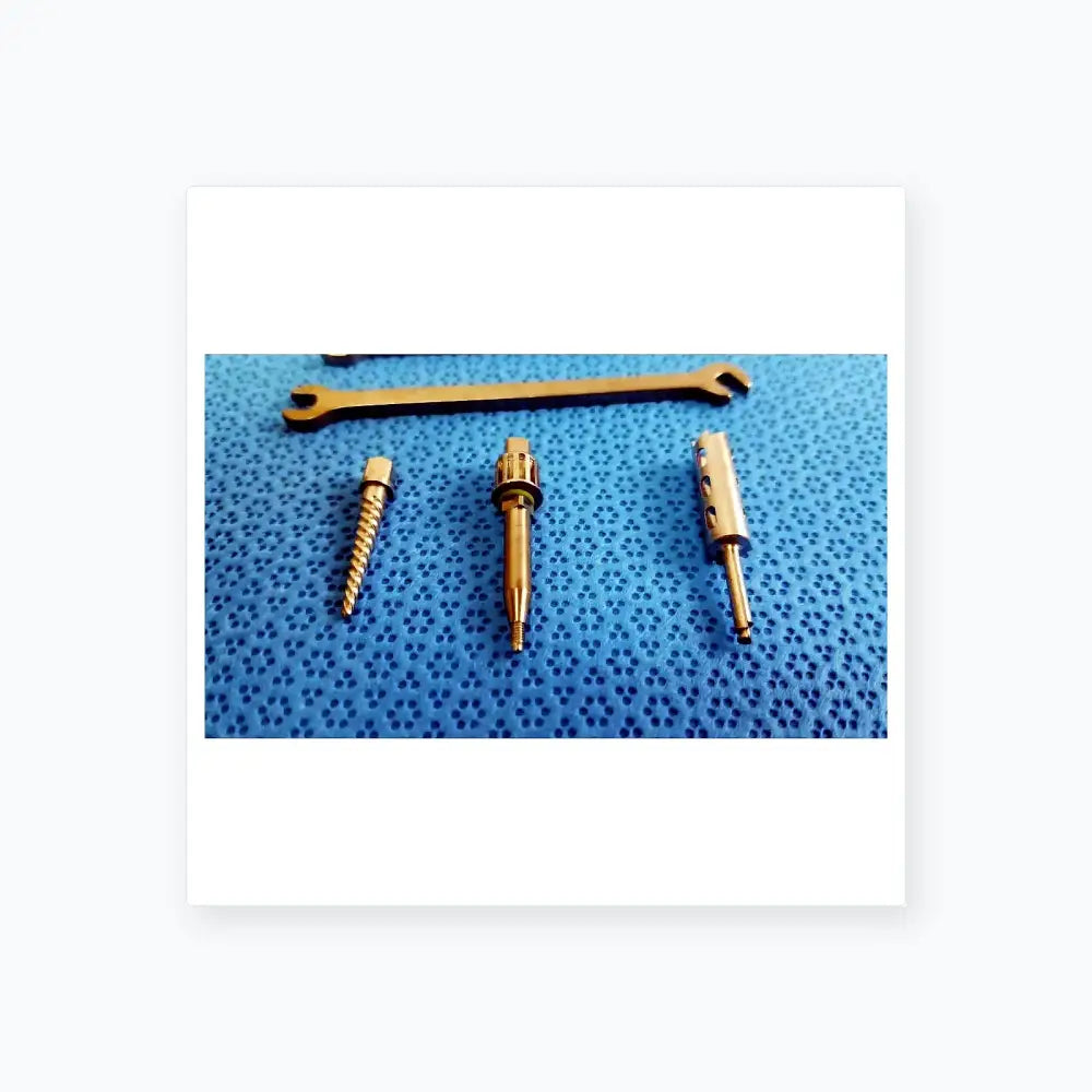 Silver surgical drill bits and wrench on blue textured surface for ace ophthalmology micro surgery medical equipment