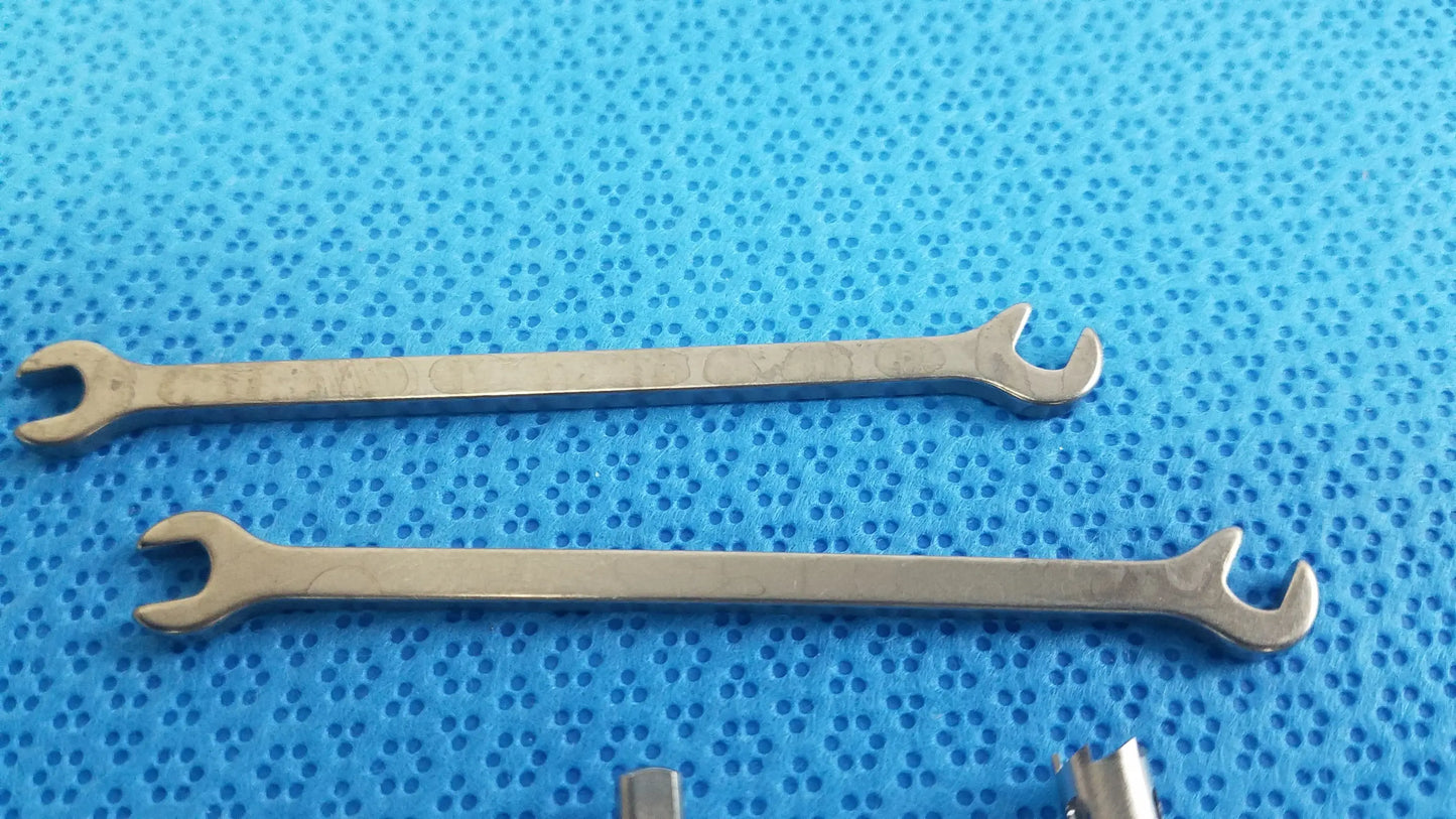 Two polished silver metallic open-end wrenches for ace ophthalmology micro surgery medical equipment reuse