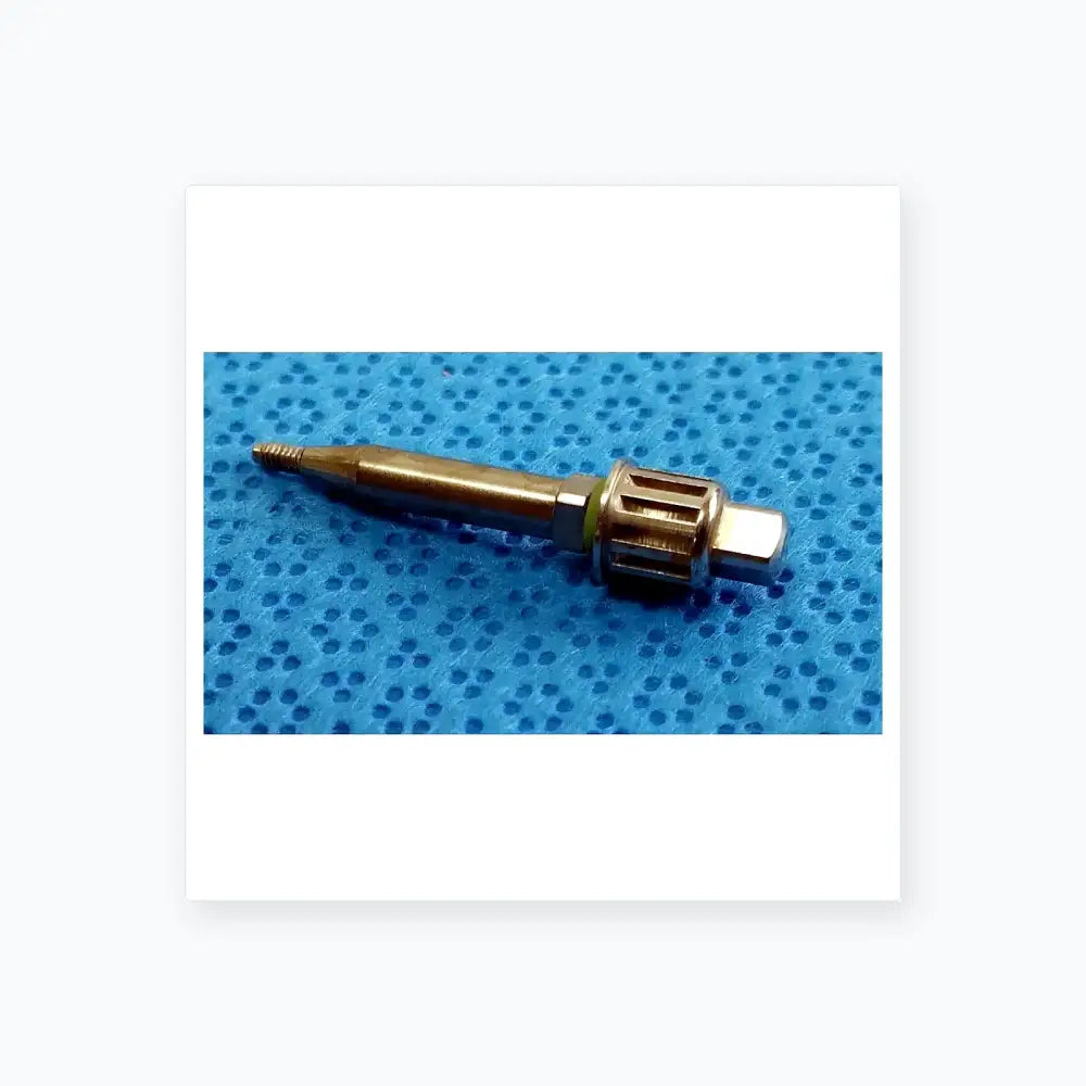 Silver-colored metallic dental implant screw with threaded tip and hexagonal head in ace ophthalmology micro surgery medical equipment tray