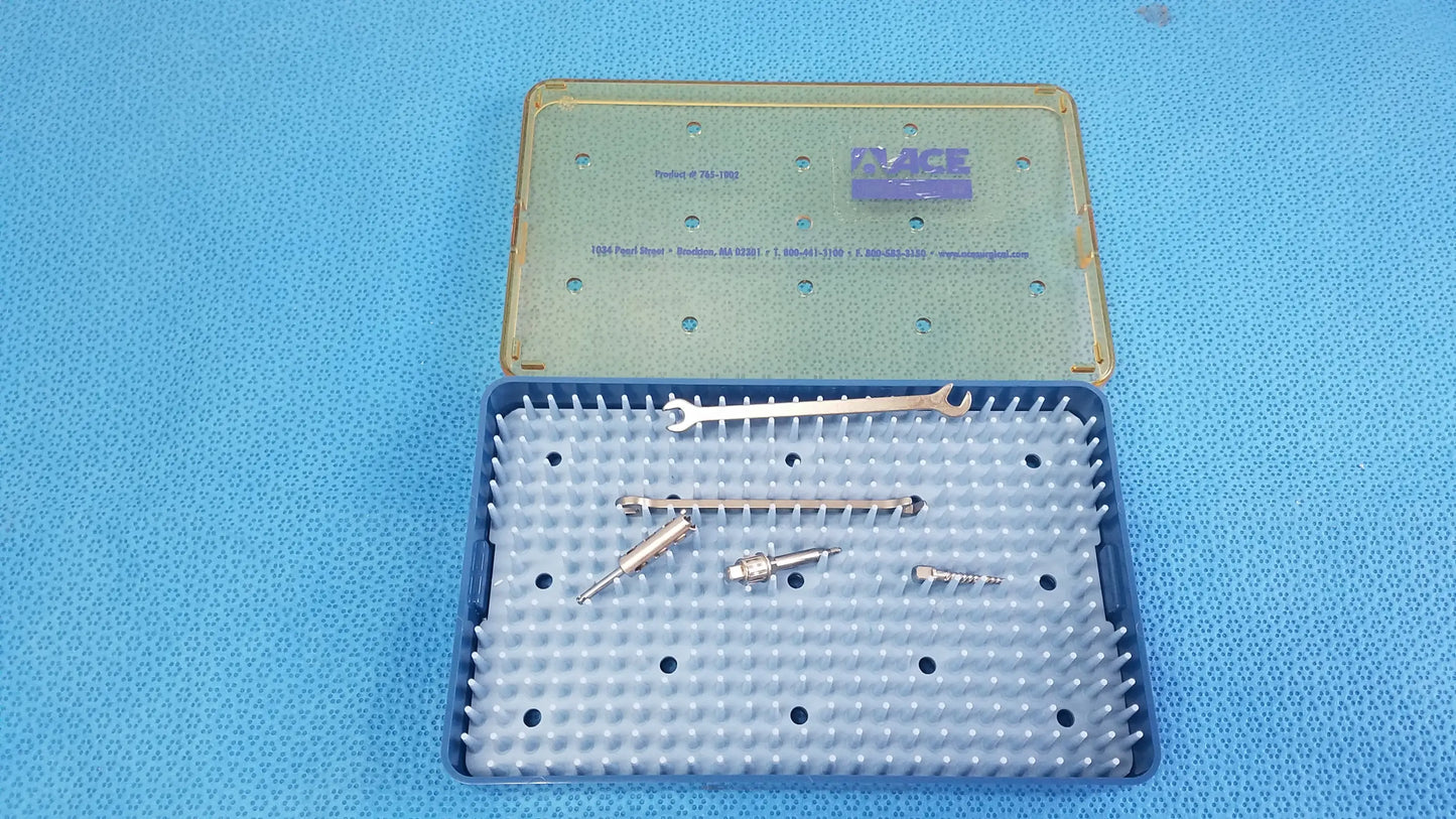 Blue plastic surgical instrument case with translucent green lid containing metallic tools for reuse medical equipment