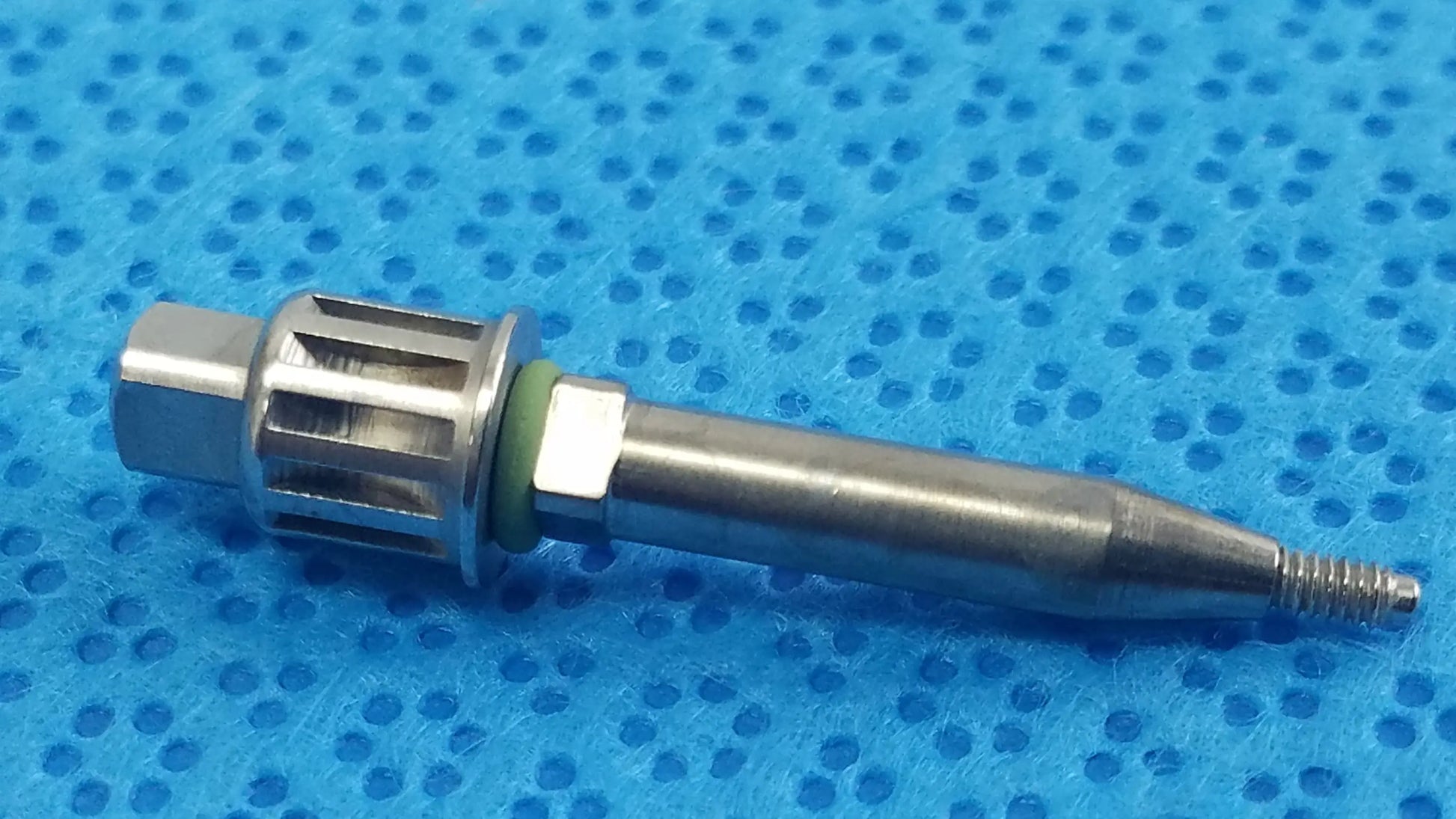 Silver metallic dental implant fixture with hexagonal head and threaded tip from smiths medical reuse medical equipment