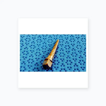 A metallic silver dental implant drill bit with hexagonal drive and spiral cutting edge for reuse medical equipment by smiths medical