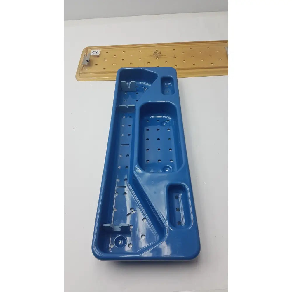 Blue plastic ACMI MRA-GT slimline sterilization and storage tray with multiple compartments and perforated sections