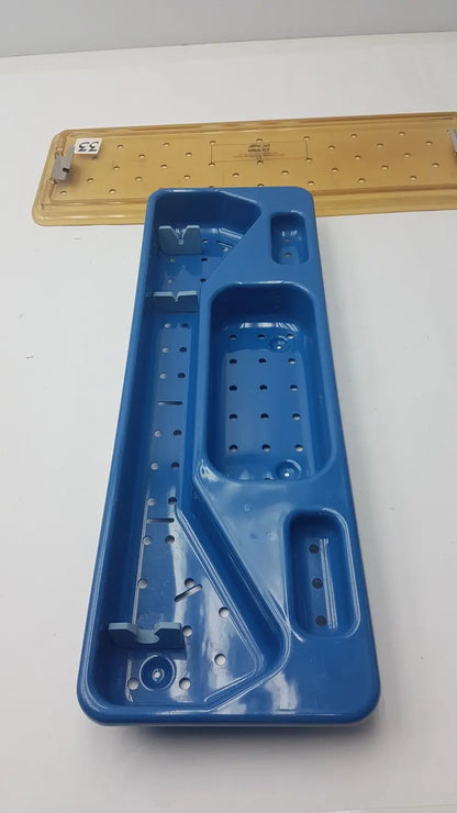 Blue plastic ACMI MRA-GT slimline sterilization and storage tray with multiple compartments and perforated sections