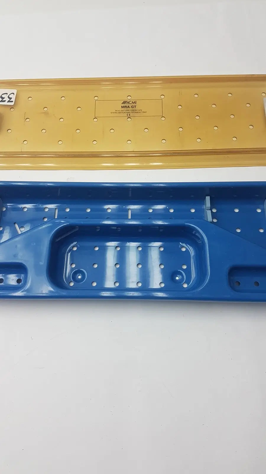 Acmi mra-gt slimline blue and yellow plastic storage tray with perforated surfaces and molded compartments for sterilization