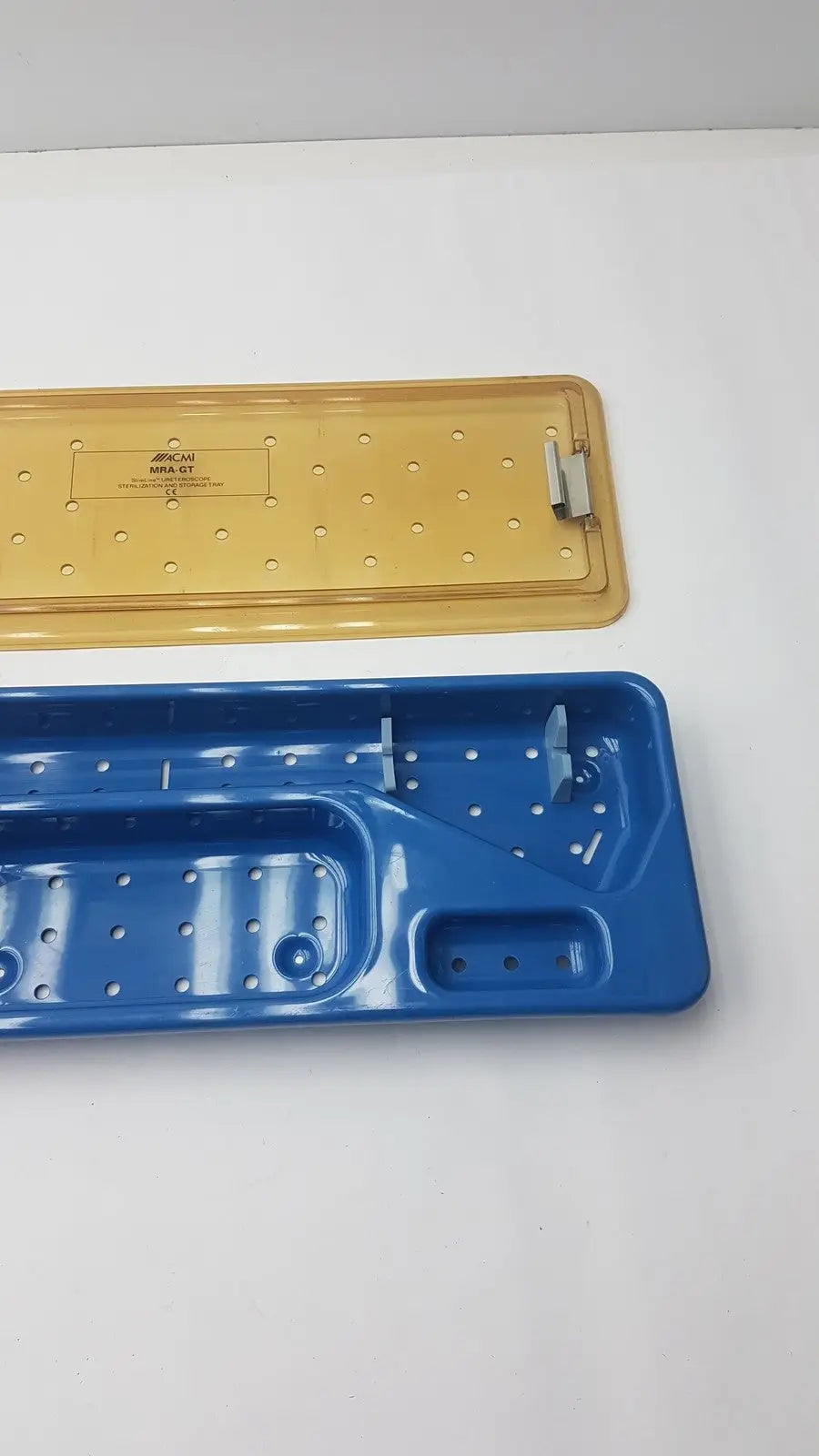 Acmi mra-gt slimline storage tray with blue and yellow plastic perforated surfaces for slimline sterilization use