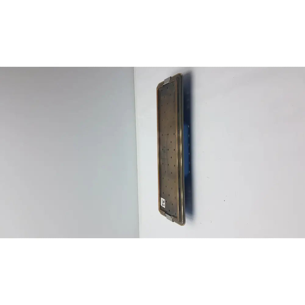 Acmi mra-gt slimline sterilization tray with a matte bronze metallic surgical plate featuring evenly spaced perforations