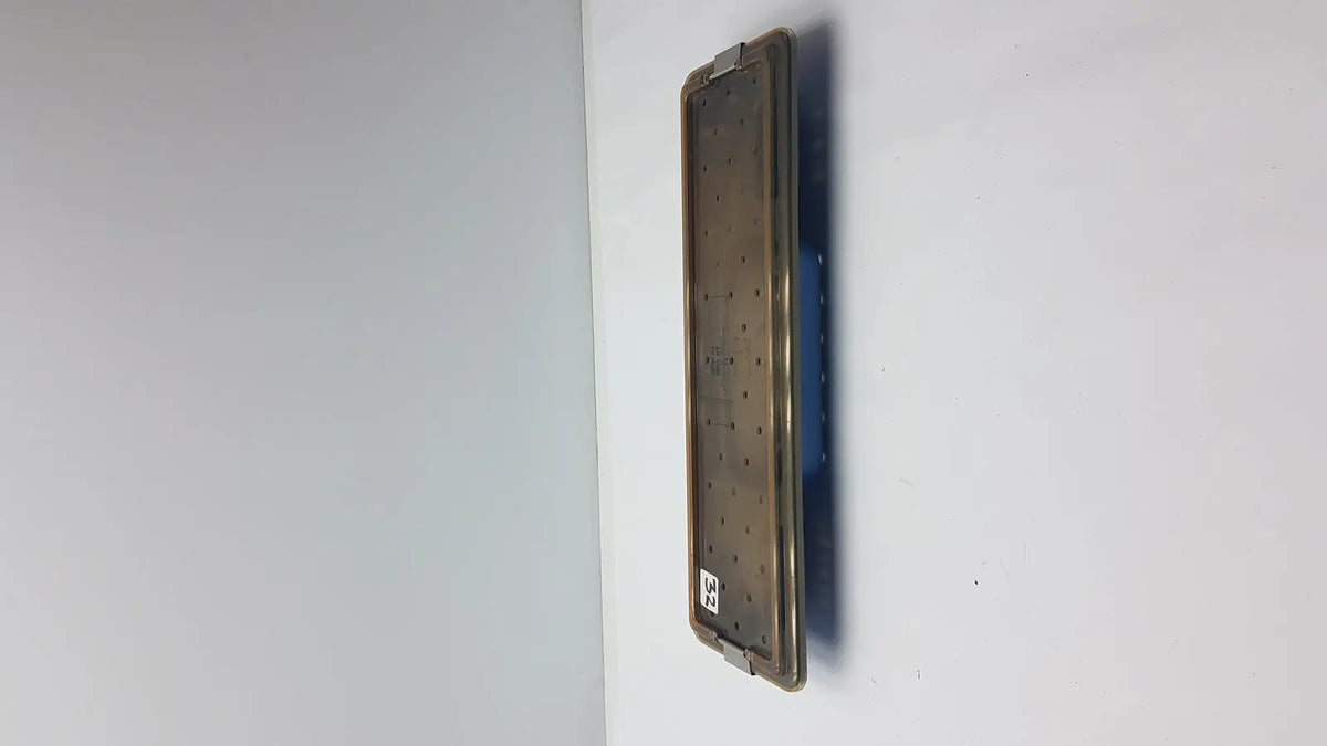Acmi mra-gt slimline sterilization tray with a matte bronze metallic surgical plate featuring evenly spaced perforations