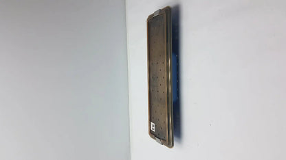 Acmi mra-gt slimline sterilization tray with a matte bronze metallic surgical plate featuring evenly spaced perforations