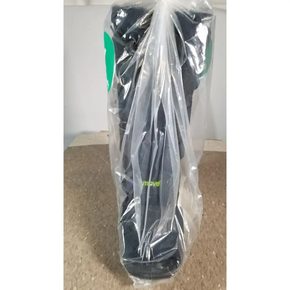Black actimove standard walker boot with green branding wrapped in clear plastic for achilles tendonitis support