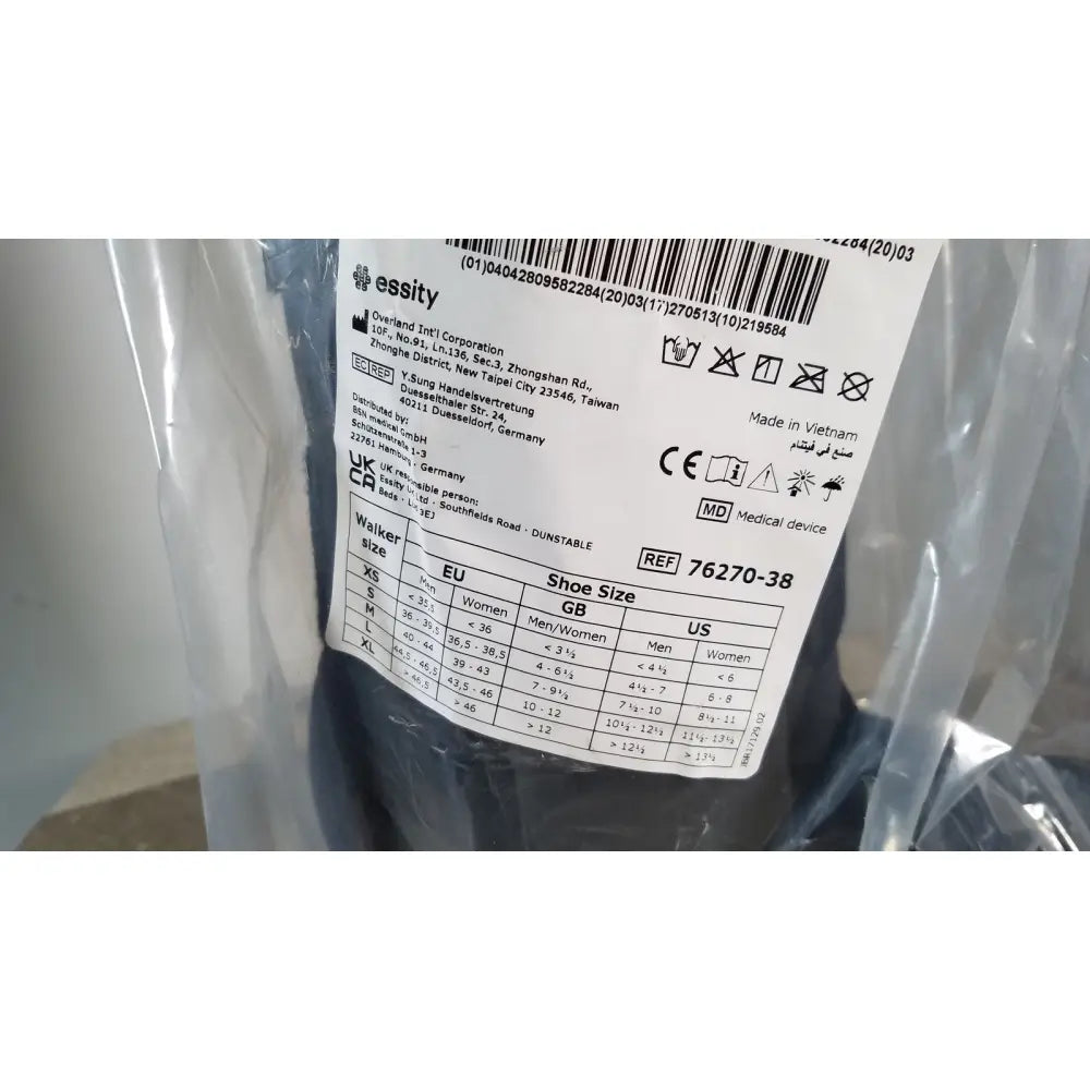The label on clear plastic packaging for actimove standard walker boot achilles high large showing size charts and manufacturing details