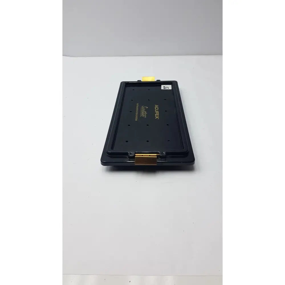Black plastic acufex suretac instrument tray with gold metal clasp and yellow tab empty suretac instrument system tray