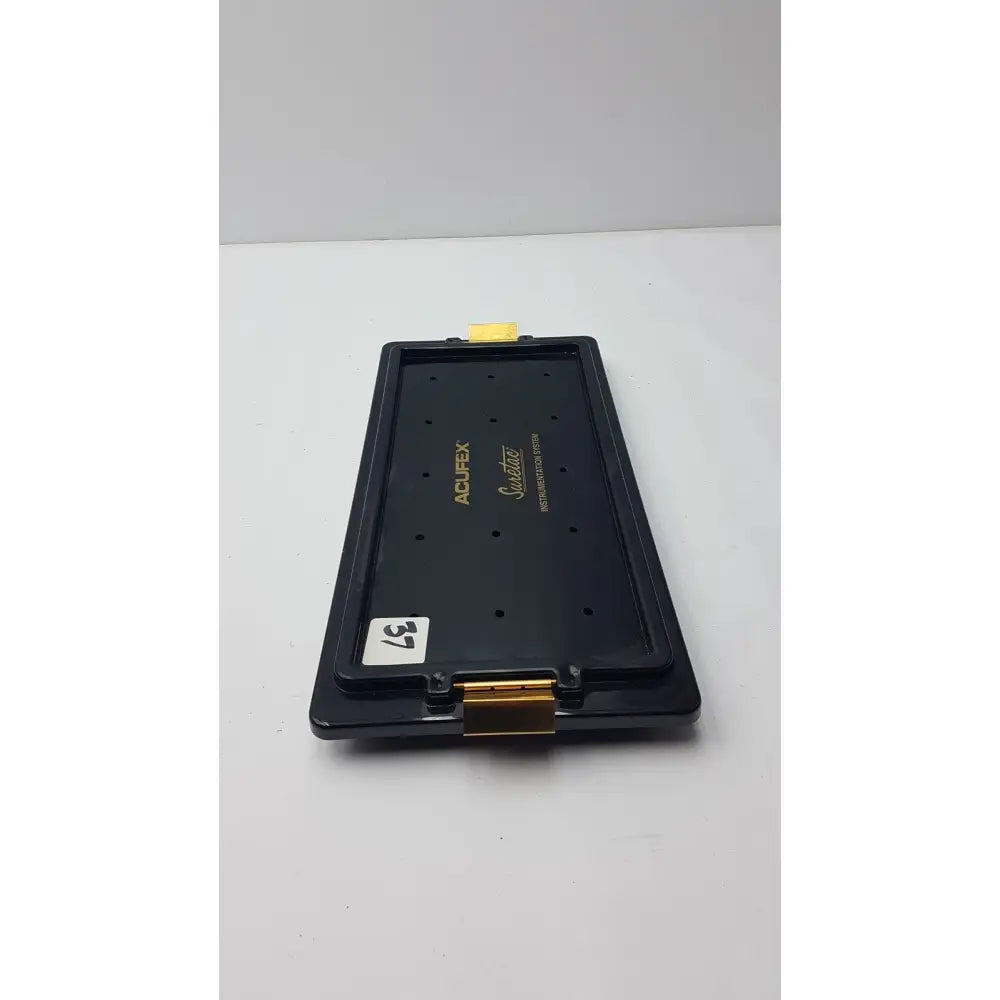 Black plastic acufex suretac instrument camera lens mount with gold metal accents and yellow tab on top for suretac instrument tray