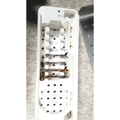 White plastic case of acumed modular hand system set containing organized metal surgical tools with engraved markings