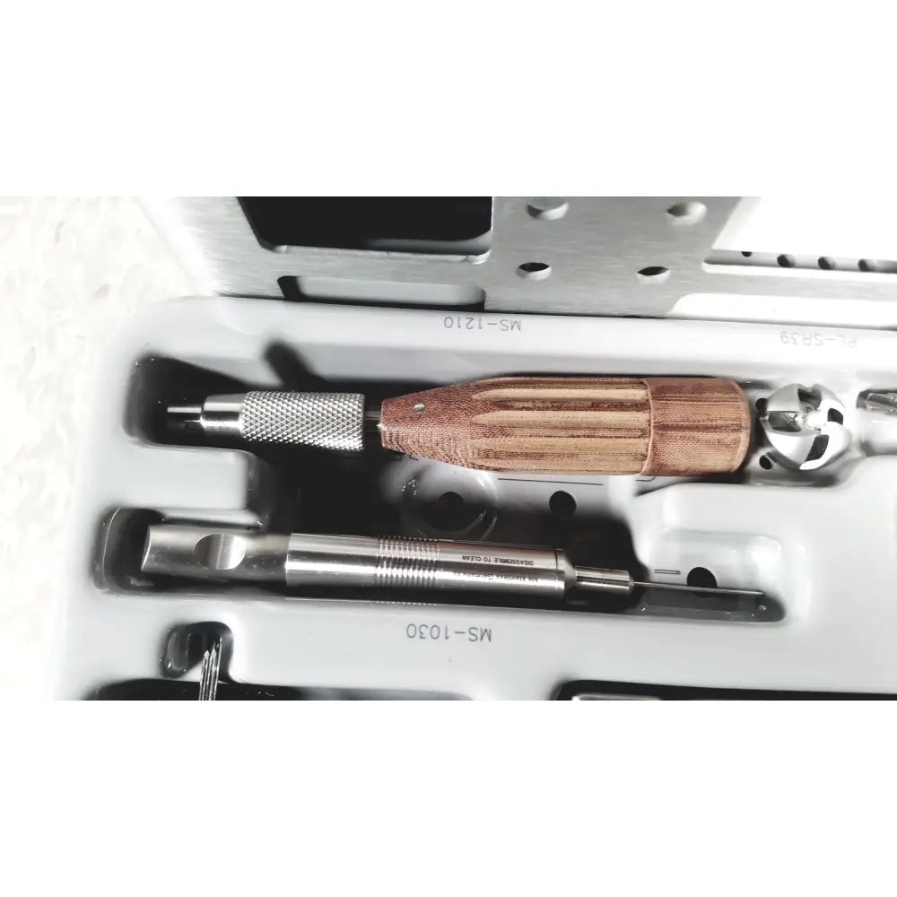 A precision surgical drill with wooden handle and engraved metallic shaft from acumed modular hand system set missing piece