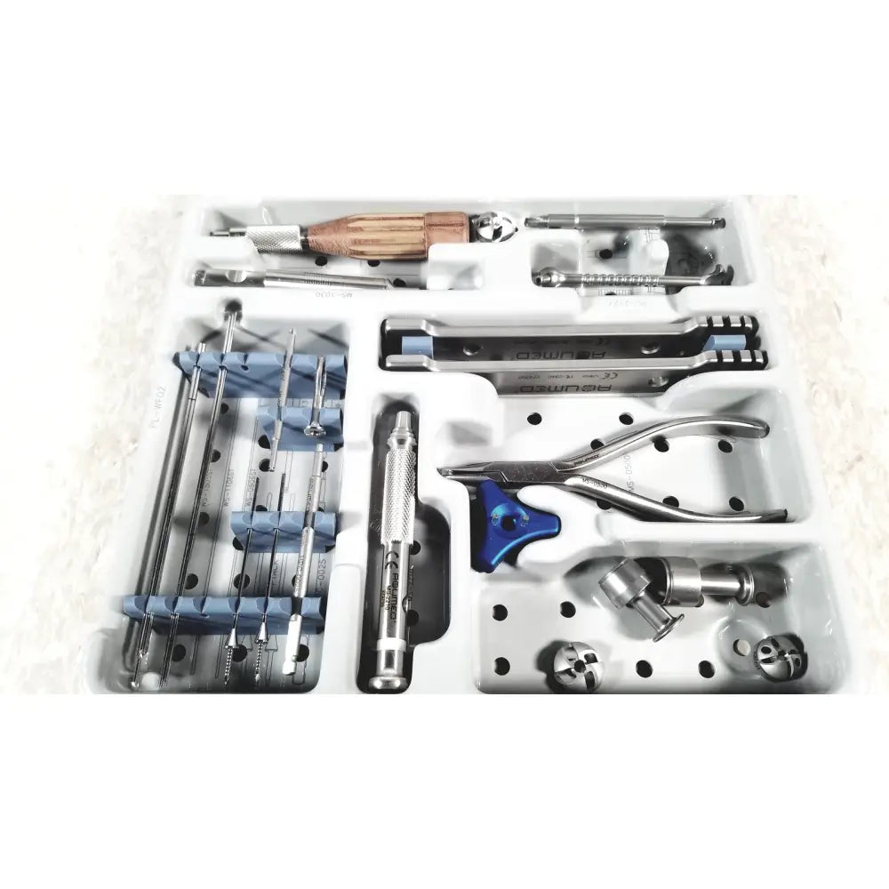 White plastic tray with metal and wooden surgical instruments including blue handled pliers in acumed modular hand set missing piece