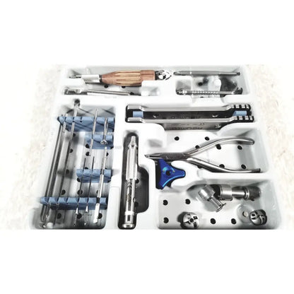 White plastic tray with metal and wooden surgical instruments including blue handled pliers in acumed modular hand set missing piece