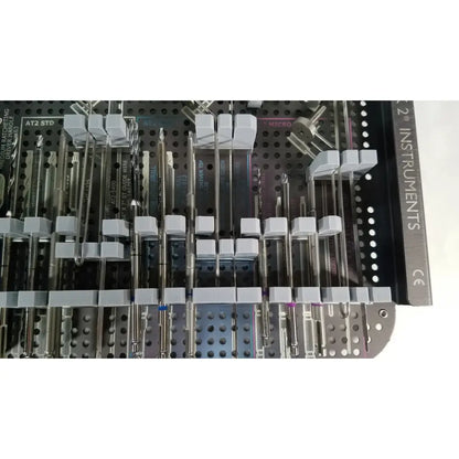 A set of metallic and white plastic handled surgical instruments in a labeled tray for the acutrak 2 headless compression screw system