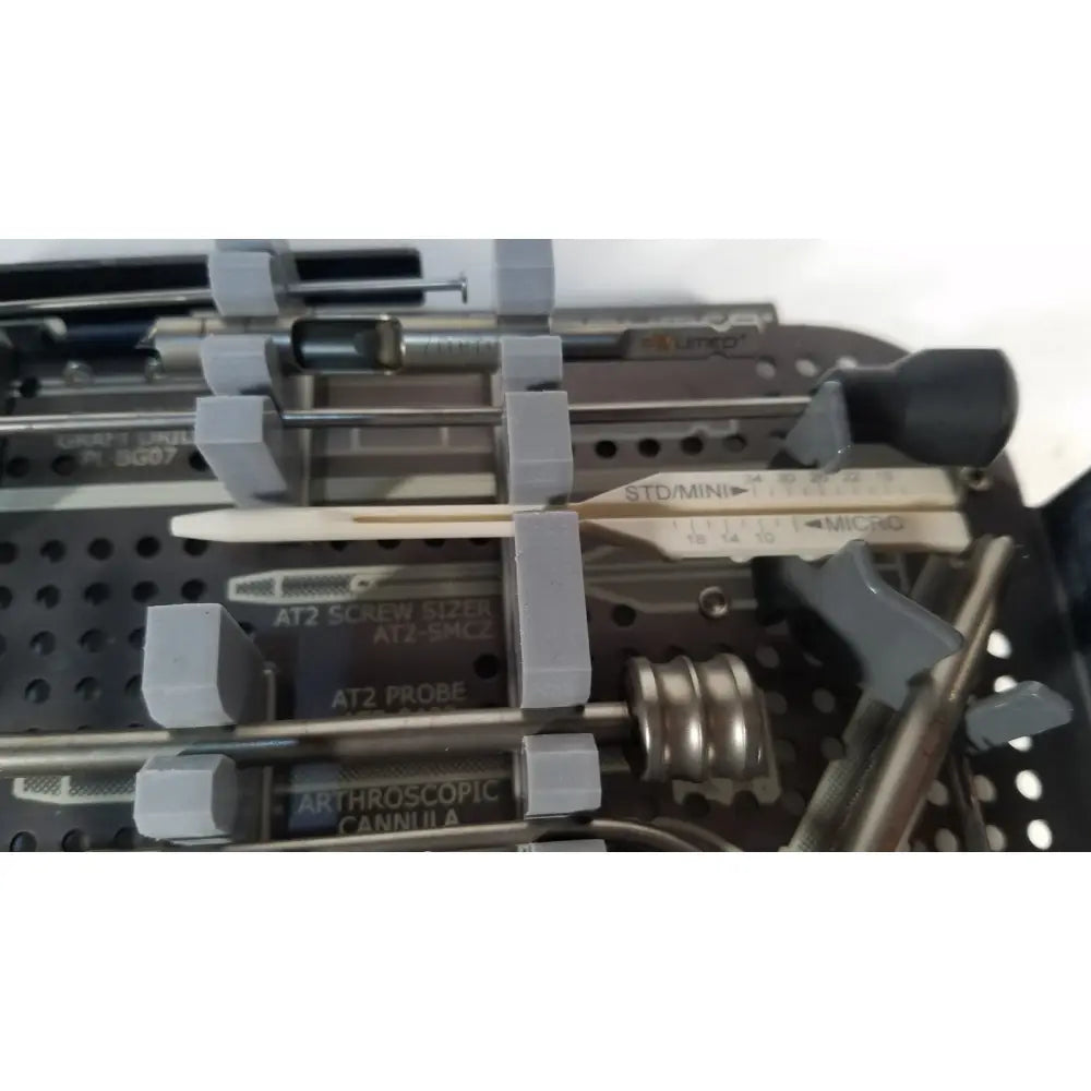 Gray plastic-handled surgical instruments with metallic shafts including at2 screw sizer and arthroscopic cannula for headless compression screw system