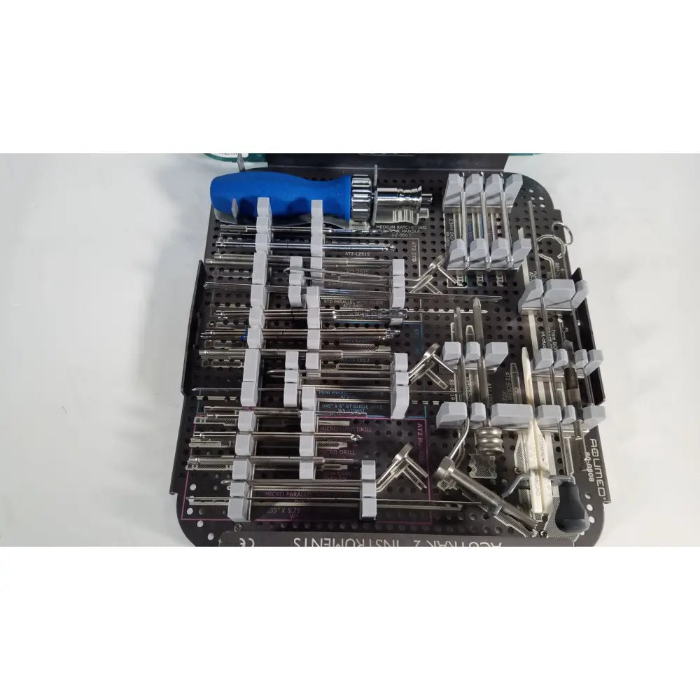 Black plastic surgical instrument tray with metal tools and blue-handled screwdriver for acutrak 2 headless compression screw system
