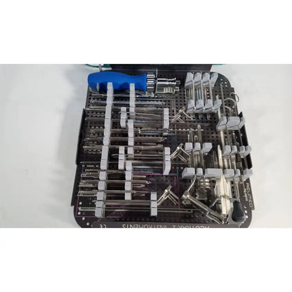Black plastic surgical instrument tray with metal tools and blue-handled screwdriver for acutrak 2 headless compression screw system
