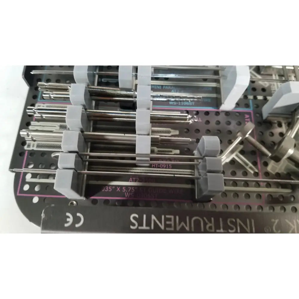 Gray plastic holders cradle stainless steel surgical instruments in a metal tray for acutrak 2 headless compression screw system reuse medical use