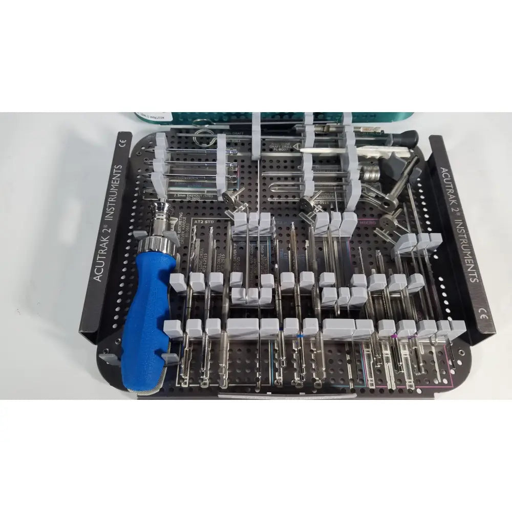 Blue-handled headless compression screw instruments in a black tray labeled acutrak 2 for reuse medical procedures