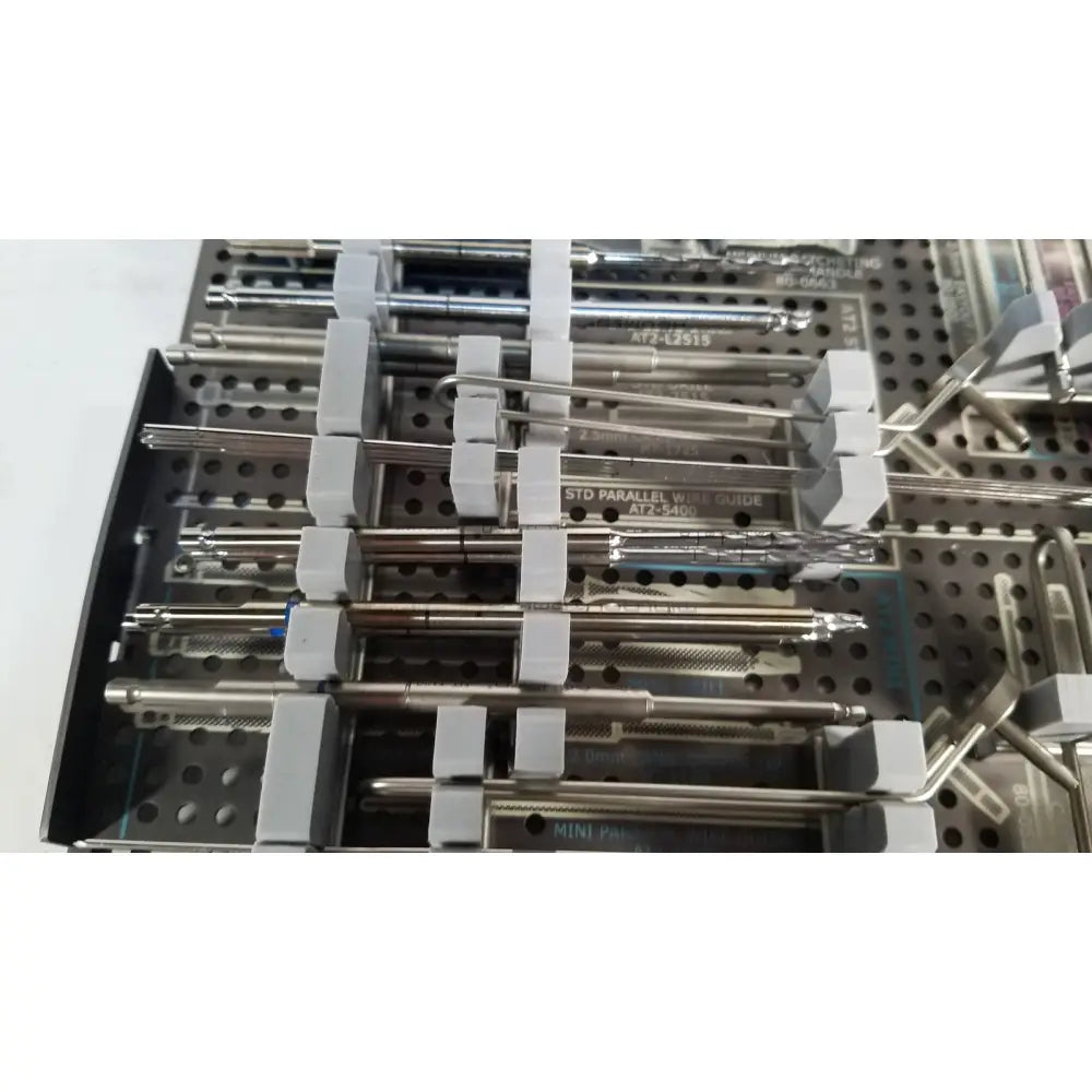 Stainless steel acutrak 2 headless compression screw system instruments organized in perforated tray with gray holders