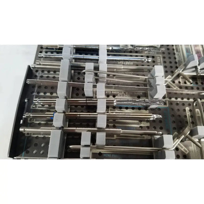 Stainless steel acutrak 2 headless compression screw system instruments organized in perforated tray with gray holders