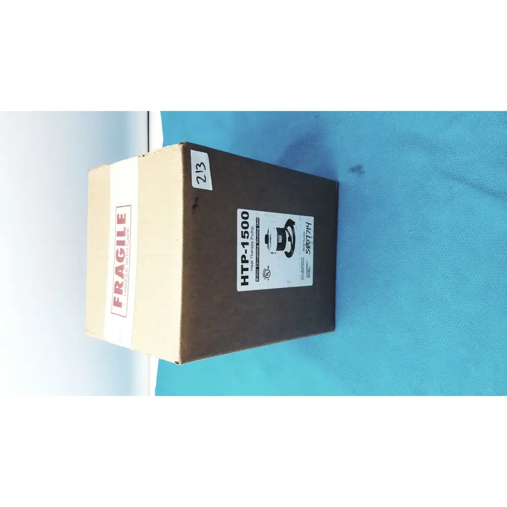 Brown cardboard box labeled htp-1500 with fragile tape containing adroit heat therapy pump for heat therapy use