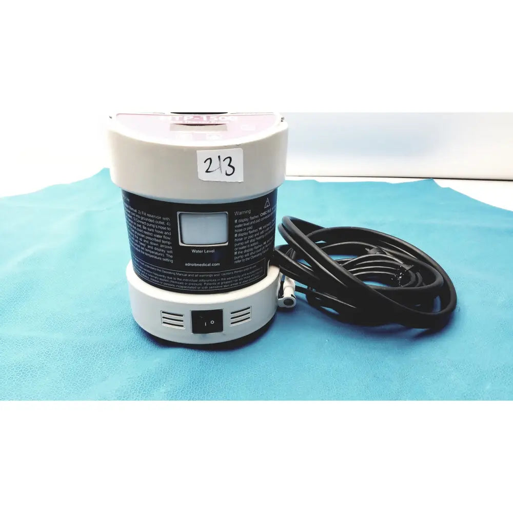 White cylindrical heat therapy pump with black label digital display and coiled black power cord for heat therapy use