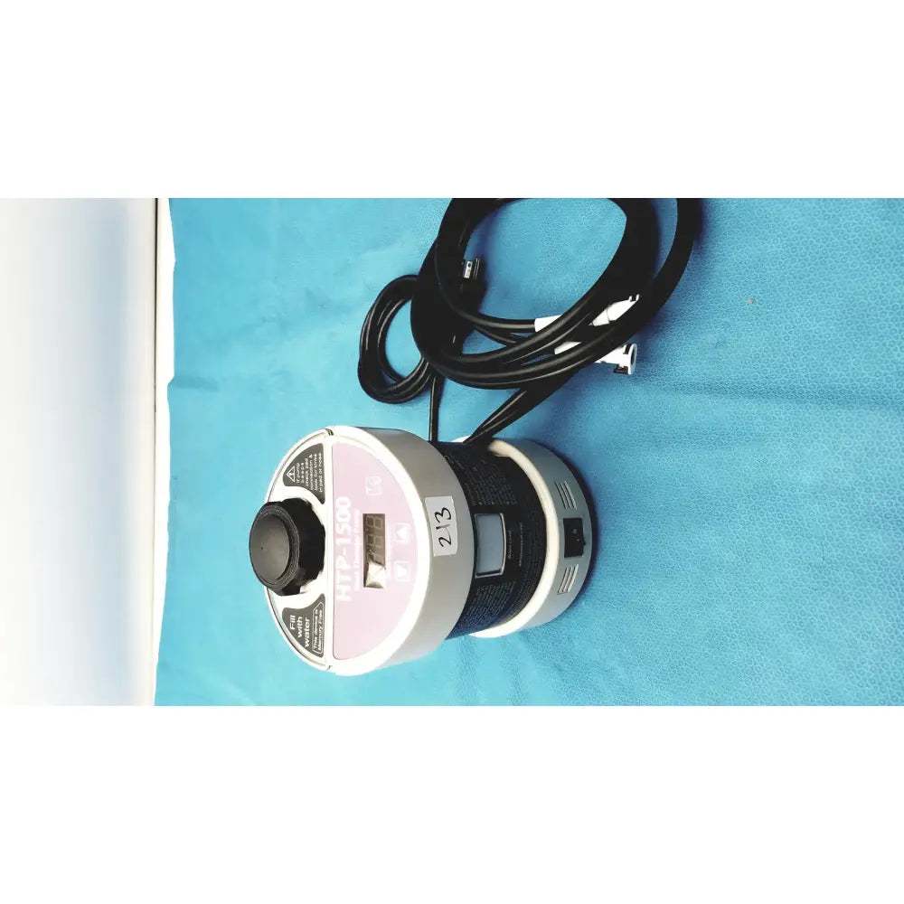 Silver and pink cylindrical heat therapy pump with black power cord labeled ttf-1500 for effective heat therapy
