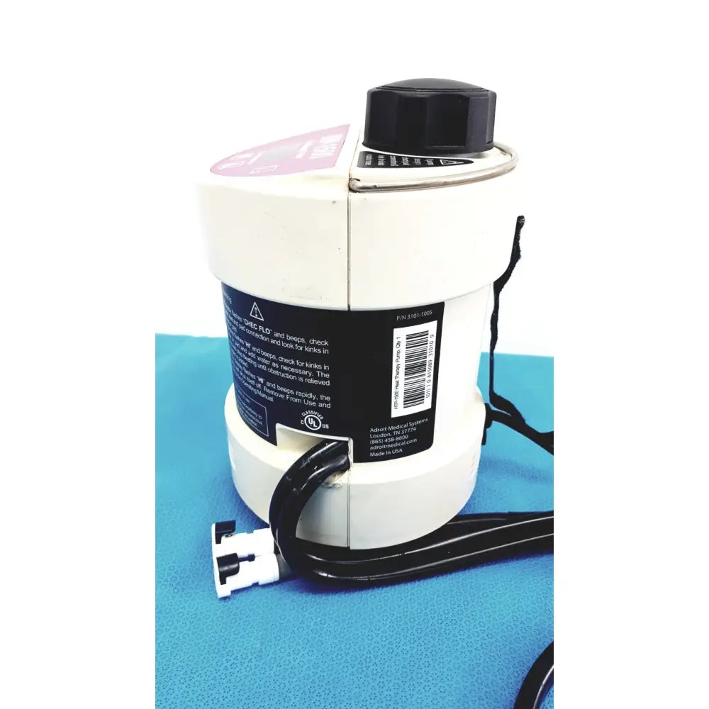 White medical-grade nebulizer with black cap and tubing by adair medical systems for portable hot cold heat therapy pump