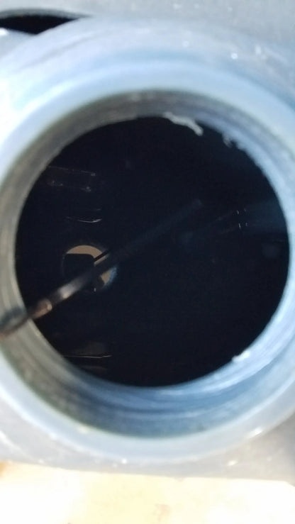 Advance es4000 ride on carpet cleaner extractor with translucent gray plastic jar containing dark liquid and metal spoon