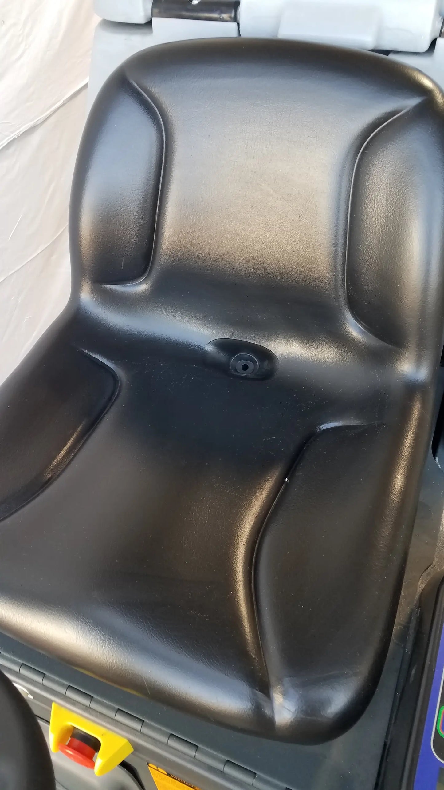 Black molded plastic seat with contoured design and circular indentation on advance es4000 carpet cleaner extractor