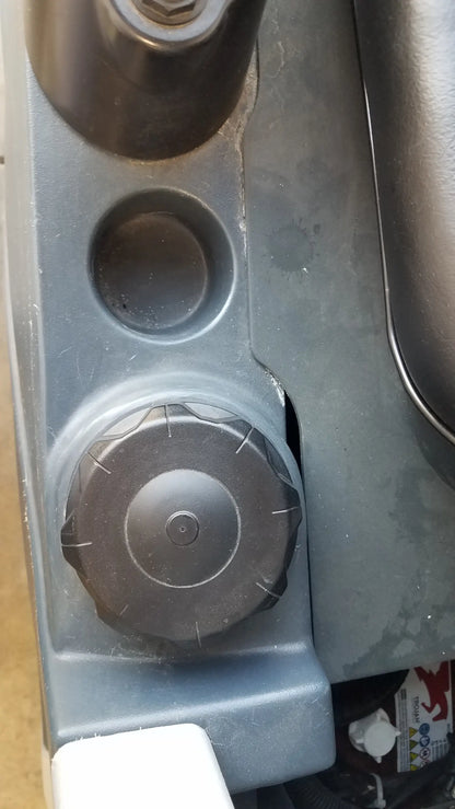 Black plastic fuel cap with textured grip and circular indentation on advance es4000 ride on carpet cleaner extractor