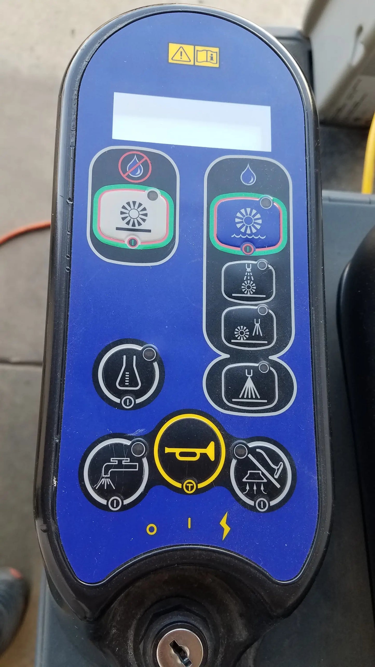 Blue control panel with black buttons for irrigation functions on advance ES4000 ride on carpet cleaner extractor