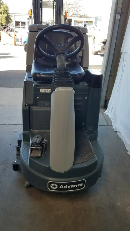 Dark green Advance ES4000 ride on carpet cleaner extractor with black steering wheel and gray padded handle