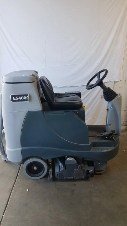 Advance es4000 ride on carpet cleaner extractor in gray and black with driver seat and scrubbing mechanism