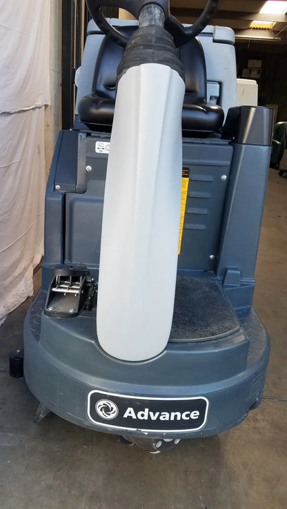 Advance es4000 ride on carpet cleaner extractor with gray body, white cylindrical cleaning head, and black steering wheel