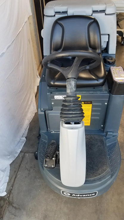 Gray advance ES4000 ride on carpet cleaner extractor with black leather seat, steering wheel, white handle grip, and yellow label