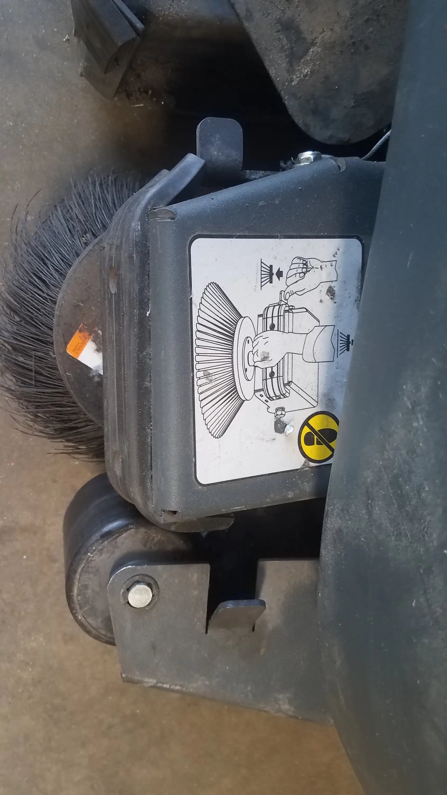 Black industrial floor brush with dense bristles and sturdy plastic housing for advance ride on carpet cleaner extractor